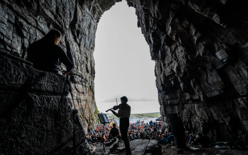 Concert during the festival of Trena in the Sanna cave. Picture taken from inside of the cave. Nord of Norway. Ellis Photography.
